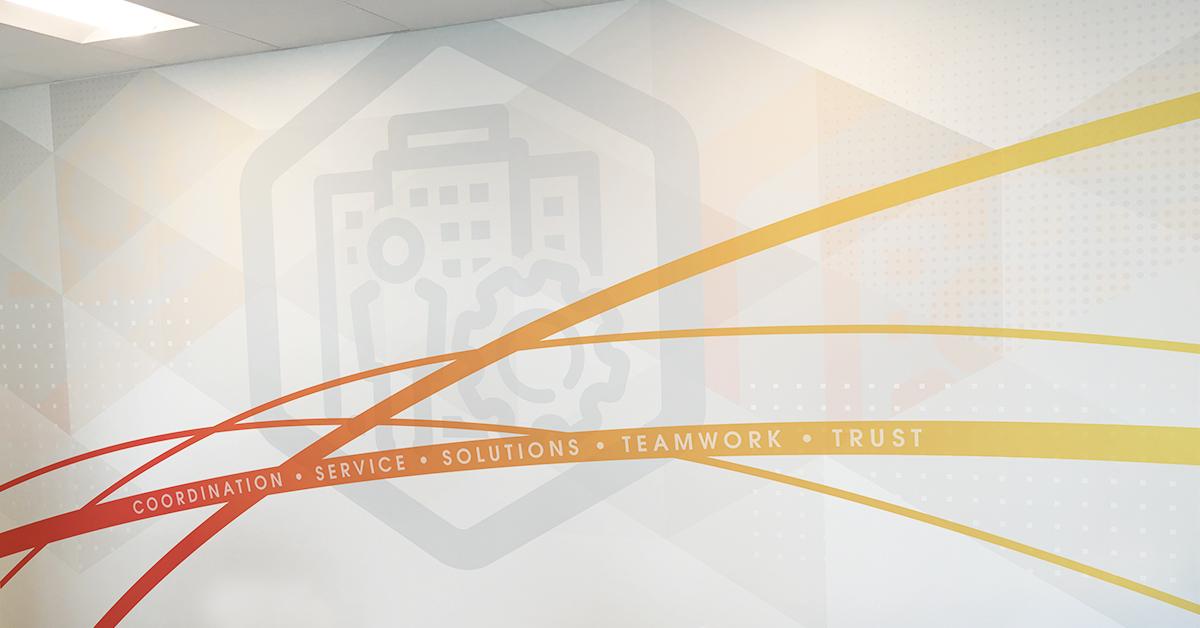 Red and orange curved lines intersect, making up the foreground of a wall mural with an industry-specific icon behind it.