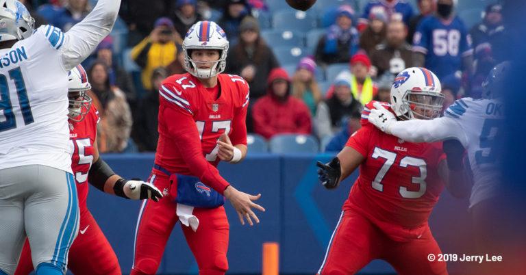 Buffalo Bills quarterback Josh Allen attempts a pass in an all-red uniform and white helmet
