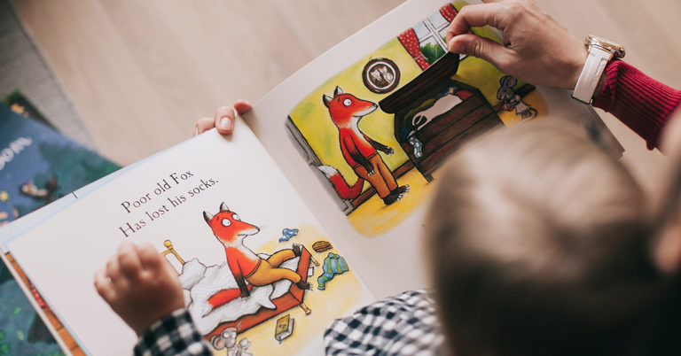 TQS takes on children's lit: We see an over-the-shoulder shot of a mother reading a classic children's book to her child.