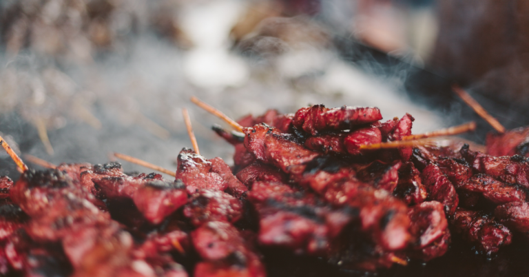 TQS takes on BBQ: A stack of reddish, char-grilled beef kebobs are stacked on top of a smoky grill.