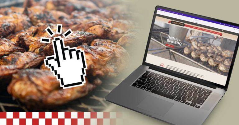 Chiavetta's website on a laptop screen overlaying some chicken cooking over charcoal with a