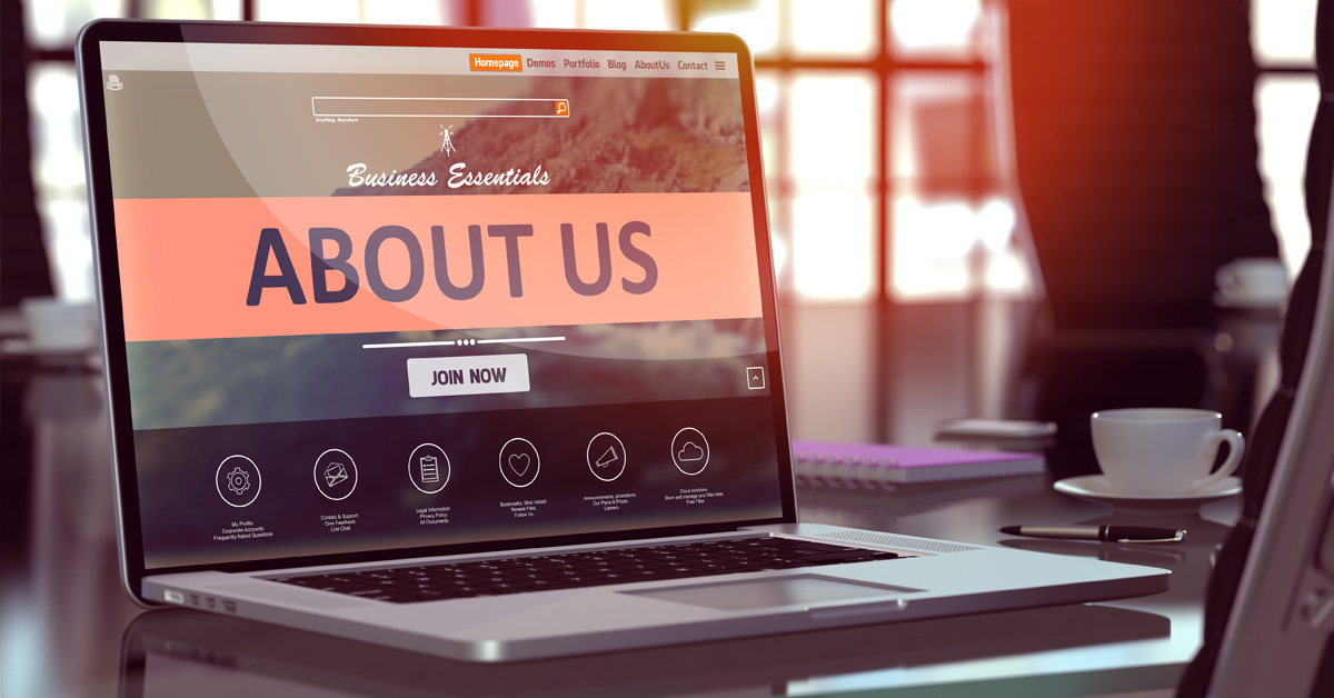 A laptop computer the an About Us page from a website showing on the screen